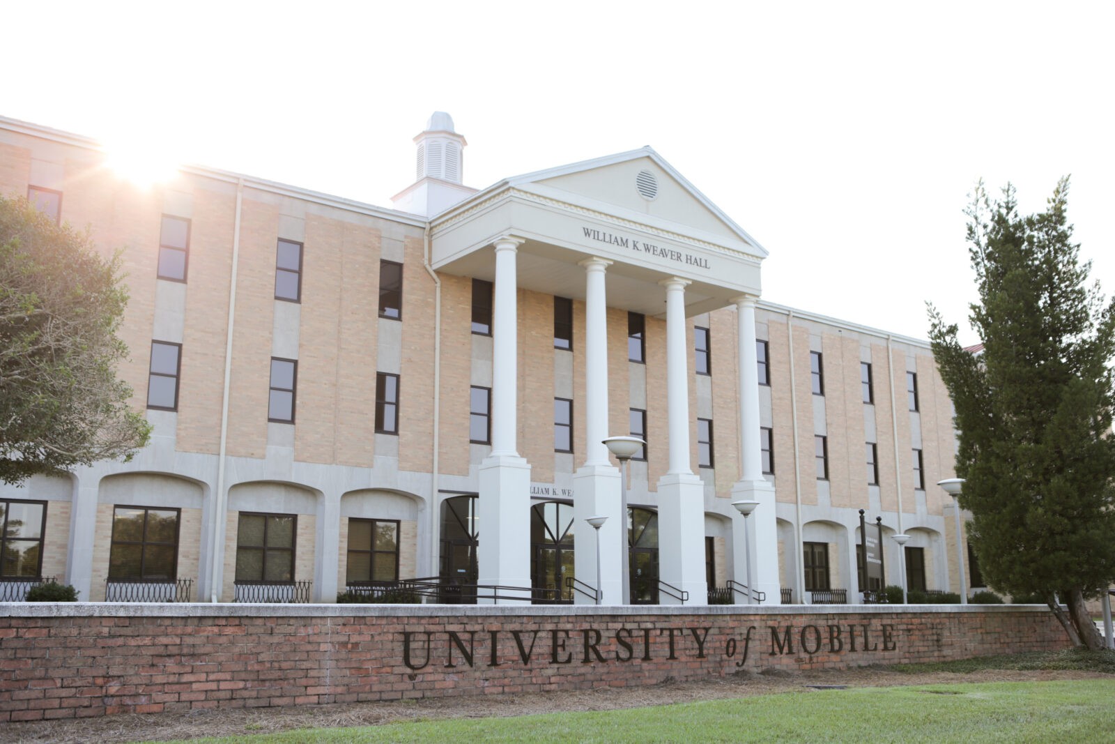 William K. Weaver Hall, University of Mobile, with columns and windows, sunlit in background.