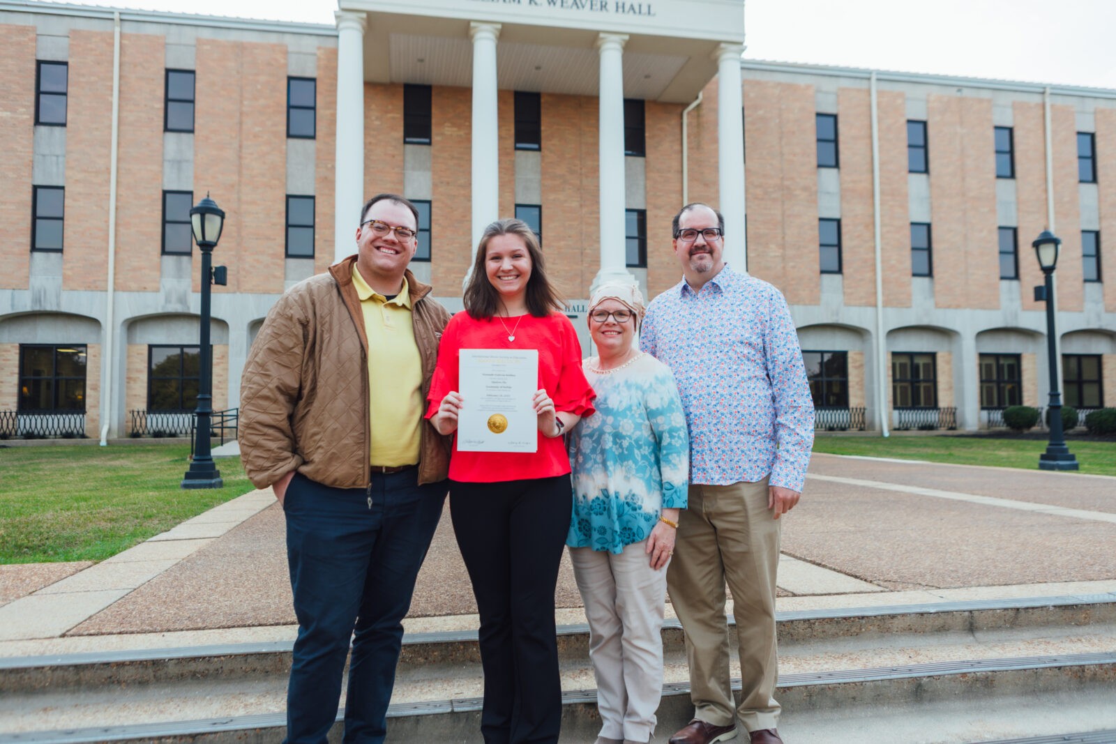 kappa delta pi girl with family with paper