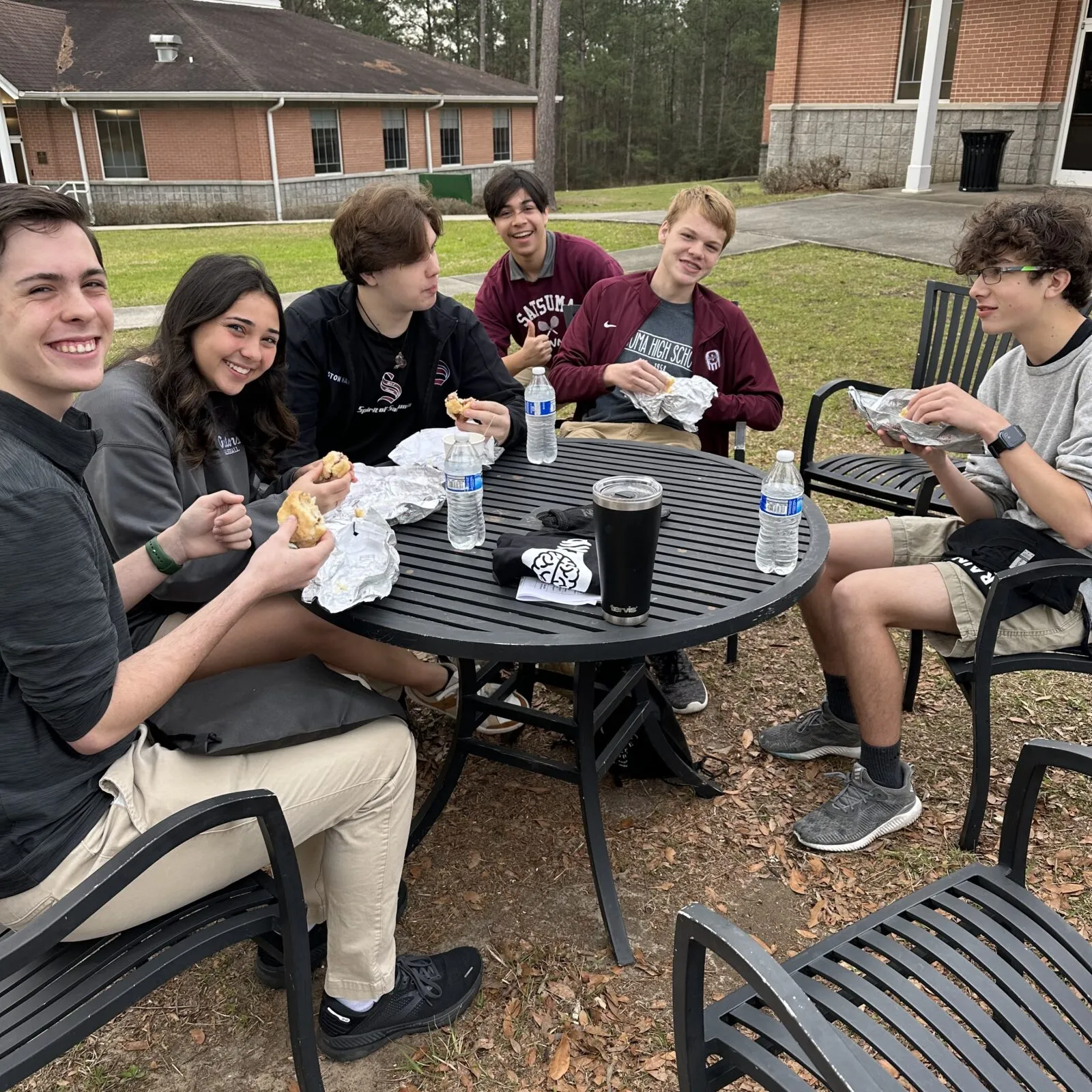 people eating outside at table