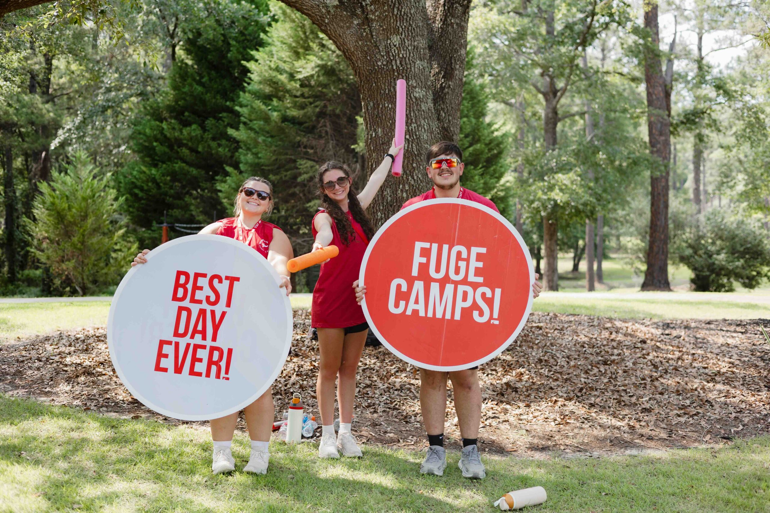 college students holding up signs that say best day ever and fuge camps